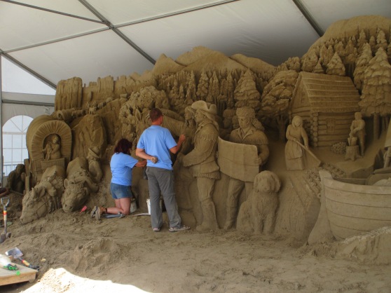 People working on an amazing sand sculpture